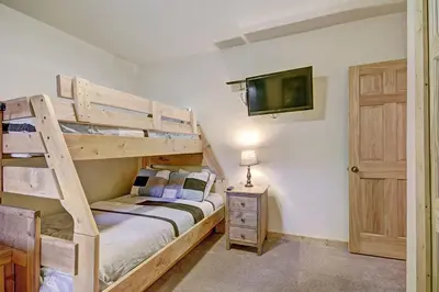 a bedroom with a bunk bed and a tv at 2609 Tenderfoot Lodge Condo in Keystone