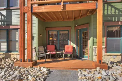 a porch with two chairs and a table on a house at 2609 Tenderfoot Lodge Condo in Keystone