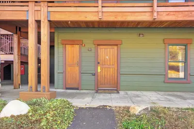 a green house with two wooden doors on it at 2609 Tenderfoot Lodge Condo in Keystone