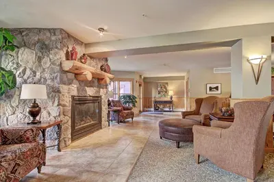 a living room with a large stone fireplace at 2609 Tenderfoot Lodge Condo in Keystone