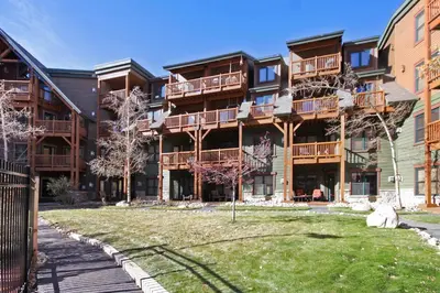 a large apartment building with a lawn in front of it at 2609 Tenderfoot Lodge Condo in Keystone