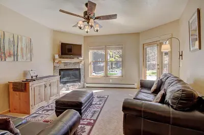 a living room with a couch and a fireplace at 2609 Tenderfoot Lodge Condo in Keystone