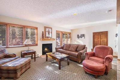 a living room with furniture and a fireplace at Boulder Brook on Fall River in Estes Park
