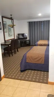 a hotel room with two beds and a table at Valley Hi Hotel in Winter Park