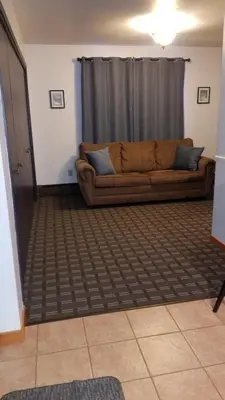 a living room with a brown couch in a room at Valley Hi Hotel in Winter Park