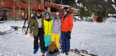 a group of people posing for a picture in the snow at Valley Hi Hotel in Winter Park