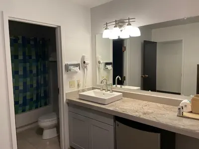 a bathroom with a sink and a toilet and a mirror at Valley Hi Hotel in Winter Park