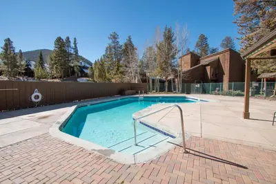 a swimming pool in a yard with a brick patio at Wild I rishman 1003 in Keystone