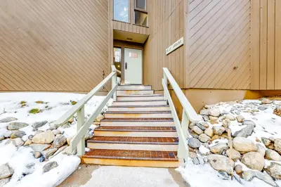 a staircase leading to a building in the snow at Wild I rishman 1003 in Keystone