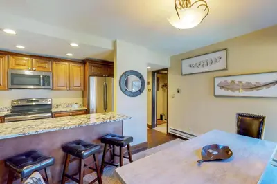 a kitchen with a table and a counter top at Wild I rishman 1003 in Keystone