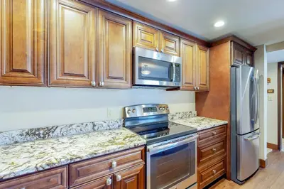 a kitchen with wooden cabinets and stainless steel appliances at Wild I rishman 1003 in Keystone