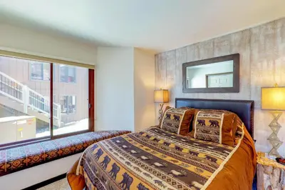 a bedroom with a bed and a window at Wild I rishman 1003 in Keystone