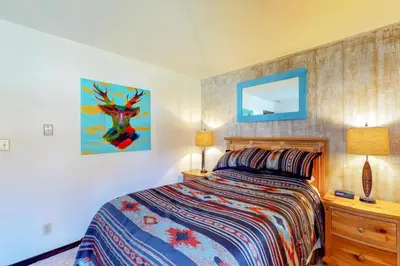a bedroom with a bed and a dresser and a mirror at Wild I rishman 1003 in Keystone