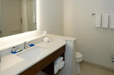 a white bathroom with a sink and a toilet at Holiday Inn Express & Suites - Aurora Medical Campus by IHG in Aurora