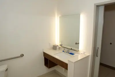 a bathroom with a sink and a mirror at Holiday Inn Express & Suites - Aurora Medical Campus by IHG in Aurora