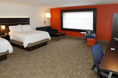 a hotel room with two beds and a large window at Holiday Inn Express & Suites - Aurora Medical Campus by IHG in Aurora
