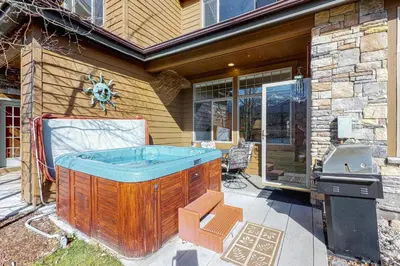 a hot tub and a grill in front of a house at Silverthorne Sanctuary in Silverthorne