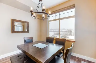 a dining room with a table and chairs and a window at Silverthorne Sanctuary in Silverthorne