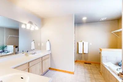 a bathroom with two sinks and a large mirror at Silverthorne Sanctuary in Silverthorne