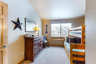 a bedroom with a bed and a dresser with a star on the wall at Silverthorne Sanctuary in Silverthorne