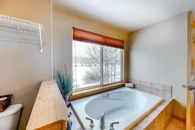 a large bath tub in a bathroom with a window at Silverthorne Sanctuary in Silverthorne