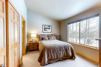 a bedroom with a bed and a large window at Silverthorne Sanctuary in Silverthorne