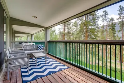 a screened porch with two chairs and a bench on a deck at Sts, Johns 2507 in Keystone