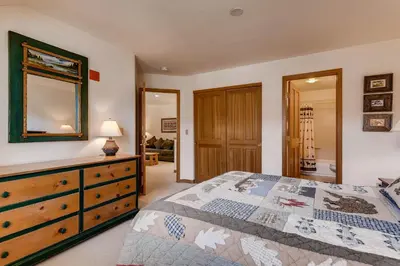 a bedroom with a bed and a dresser with a mirror at Gateway 5039 in Keystone