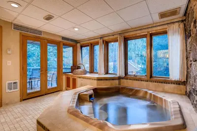 a large bath tub in a room with windows at Chateaux DuMont 2724 in Keystone