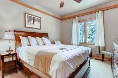 a bedroom with a large bed and a window at Chateaux DuMont 2724 in Keystone