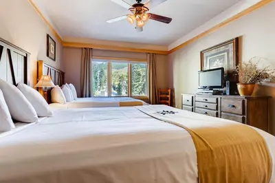 a bedroom with two beds and a television in it at Chateaux DuMont 2724 in Keystone