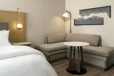 a hotel room with a bed and a couch and a table at The Westin Denver Downtown in Denver