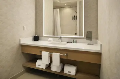 a bathroom with a sink and a mirror and towels at The Westin Denver Downtown in Denver