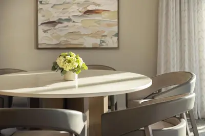 a white table with chairs and a vase of flowers on it at The Westin Denver Downtown in Denver