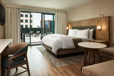 a hotel room with a bed and a balcony at The Westin Denver Downtown in Denver