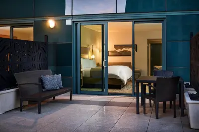 a hotel room with a bed and a table and chairs at The Westin Denver Downtown in Denver