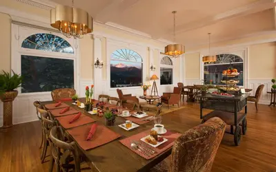 a dining room with a long table and chairs at The Stanley Hotel in Estes Park