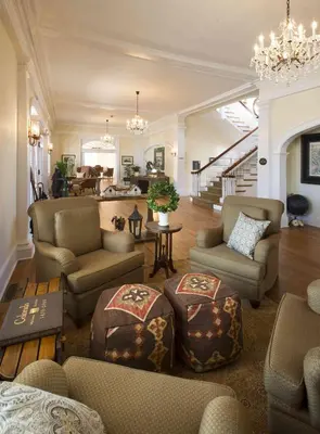 a living room with couches and a chandelier at The Stanley Hotel in Estes Park