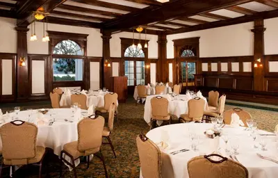 a banquet hall with white tables and chairs at The Stanley Hotel in Estes Park