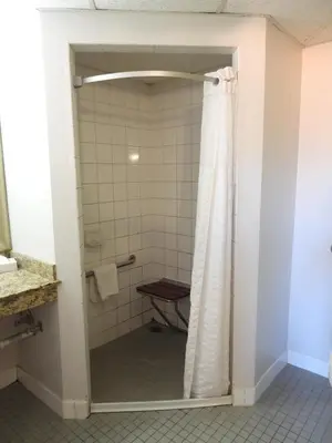 a bathroom with a shower with a shower curtain at Super 8 by Wyndham Westminster Denver North in Westminster