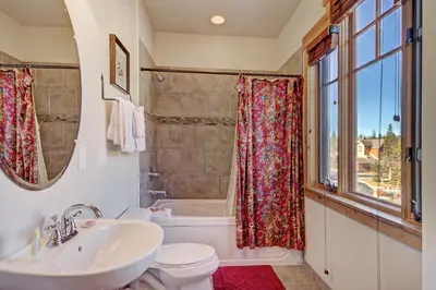 a bathroom with a sink and a tub and a toilet at 6508 Settlers Creek Townhomes in Keystone