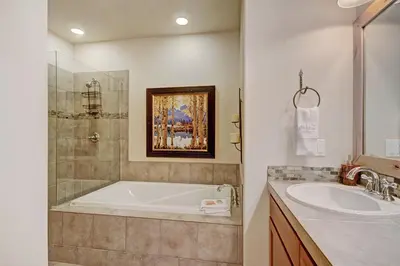 a bathroom with a tub and a sink at 6508 Settlers Creek Townhomes in Keystone