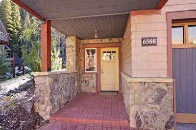 a front door of a house with a stone wall at 6508 Settlers Creek Townhomes in Keystone