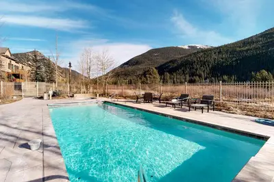 a swimming pool with mountains in the background at Red Hawk Lodge 2254 in Keystone