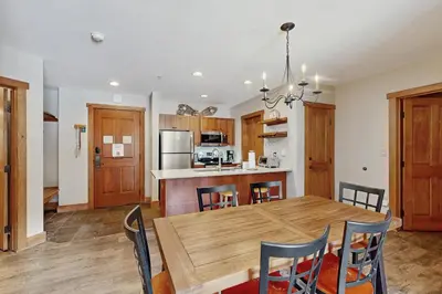 a kitchen and dining room with a wooden table and chairs at Red Hawk Lodge 2254 in Keystone
