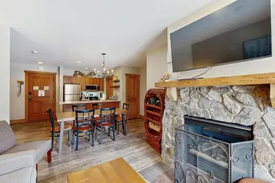 a living room with a fireplace with a tv on top at Red Hawk Lodge 2254 in Keystone