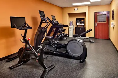 a gym with three exercise bikes in a room at Hampton Inn Longmont in Longmont