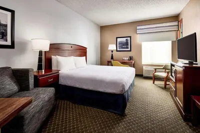 a hotel room with a bed and a couch at Hampton Inn Longmont in Longmont