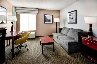 a living room with a couch and a desk at Hampton Inn Longmont in Longmont