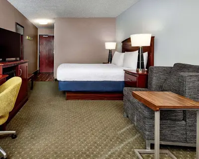 a hotel room with a bed and a couch at Hampton Inn Longmont in Longmont